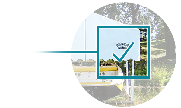 Beach King logo on a white canopy with a checkmark overlay, set against a backdrop of grass and trees.