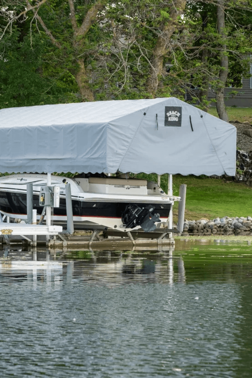 Boat lift with gray canopy on a calm lake